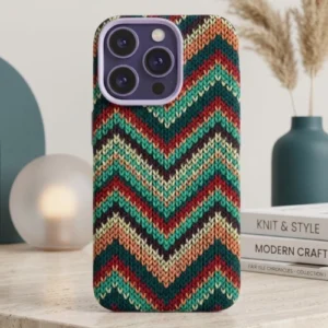 Ultra-slim magnetic iPhone case with a textured green chevron knit pattern, soft silicone grip, and raised camera protection, displayed on a minimalist tabletop with decorative objects