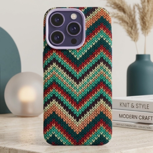 Ultra-slim magnetic iPhone case with a textured green chevron knit pattern, soft silicone grip, and raised camera protection, displayed on a minimalist tabletop with decorative objects